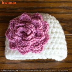 a crocheted hat with a flower on it