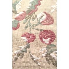 a close up view of the fabric with flowers and leaves in red, green, white and beige colors