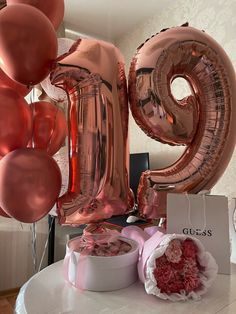 a table with balloons and gifts for someone's 21st birthday or other special occasion