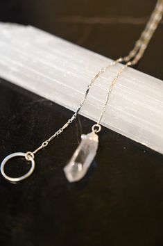 A Quartz necklace unlike any other! This beautiful & timeless Quartz lariat necklace weaves through the circle, allowing you to adjust where the circle sits on your chest. Quartz is the Power Stone, helping you see the Vision you are creating for your life and walk that path with crystal clarity. Pair this gorgeous lariat necklace with our Circle of Life Necklace. Clear Quartz pendant approximately 3/4" in length Sterling silver bar chain and circle ring Necklace is a singular chain without a cl Nickel Free Sterling Silver Lariat Necklace, Adjustable Sterling Silver Crystal Necklace, Adjustable Dainty Round Lariat Necklace, Adjustable Round Lariat Necklace In Dainty Style, Spiritual Lariat Necklace With Adjustable Chain, Bohemian Lariat Necklace With Delicate Chain As Gift, Adjustable Sterling Silver Lariat Necklace - Spiritual, Adjustable Sterling Silver Lariat Necklace For Spiritual Style, Spiritual Lariat Crystal Necklace For Gift