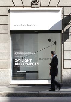 a man walking down the street in front of a building