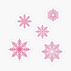 four pink snowflakes stickers on a white background