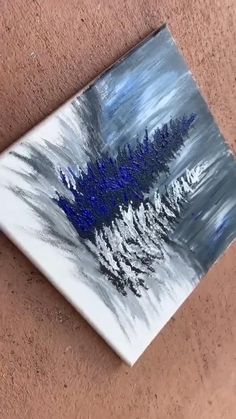 a painting on the wall with blue and white colors