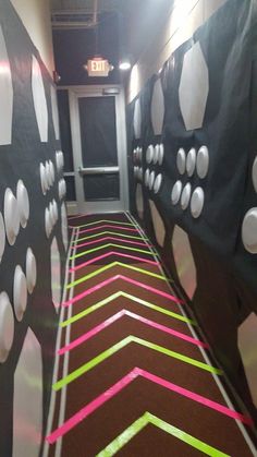 the hallway is decorated with black, white and pink wallpaper that matches the carpet