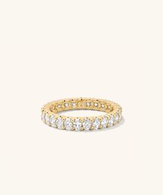 a yellow gold ring with white diamonds