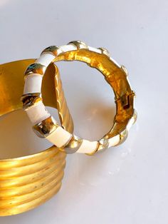 "Vintage Enamel Clamper Bracelet, Original by Robert, 1950s Designer Bangle, White Enamel with Gold Tone Accents, Signed and Numbered, Pin Up Accessories Sleek and Simple, this classic enamel clamper bracelet is signed inside \"Original by Robert\" and is numbered 0331. Slight wear due to age and use, but still in terrific vintage condition. Inside circumference is 6 1/2\"  Curved width is 1\"" Katie Hill, Bracelet Original, 1950s Bracelet, December 30, December 19, December 21, Bangle Designs, White Enamel, Leather Bracelet