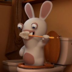 a cartoon bunny is brushing his teeth on the toilet