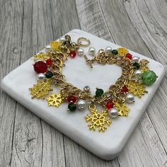 This golden snowflake charms chain bracelet is handcrafted personally for me, Derlis. You can Pick your size bracelet and favorite style: green/red/white or blue/golden/white beads. Also, you can pick your size bracelet. Each bracelet has about 9 assorted snowflake charms. Perfect Christmas gift for family, friends, love ones, co-workers, or yourself. MATERIALS:   - Antique golden Tibetan style Snowflake charms: Assorted sizes and styles - Pearl white glass round beads, 6mm - Rondelle faceted gl Handmade Gold Charm Bracelet As Gift, Handmade Gold Charm Bracelet For Gift, Handmade Gold Charm Bracelet For Gift Making, Handmade Christmas Jewelry Bracelets, Gold Bracelets As Christmas Gifts, Handmade Christmas Bracelet Jewelry, Gold Bracelets For Christmas Gift, Handmade Christmas Bracelet, Handmade Gold Jewelry For Christmas