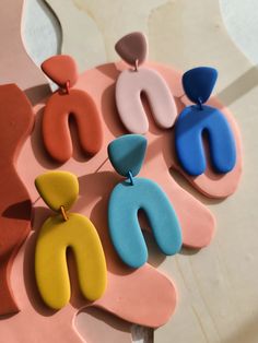 several different colored earrings on top of each other