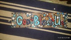 a wooden sign that says god bless u s with stars and hearts on it