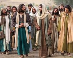 a group of men dressed in biblical clothing standing next to each other on a dirt road