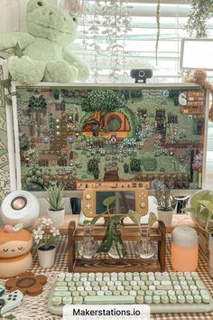 a table topped with lots of potted plants next to a computer