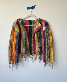 a multicolored jacket hanging on a wall