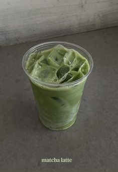 a green smoothie in a plastic cup