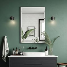 a bathroom with green walls and a white sink