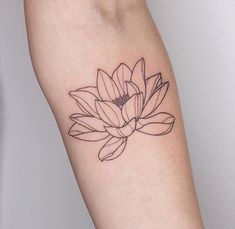 a woman's arm with a flower tattoo on the left side of her body