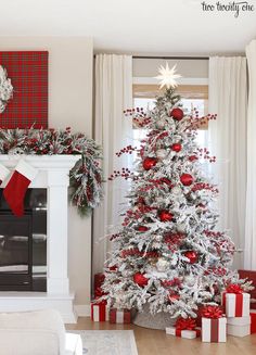 a white christmas tree with red and silver ornaments