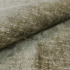 a close up view of a carpet with white spots on it