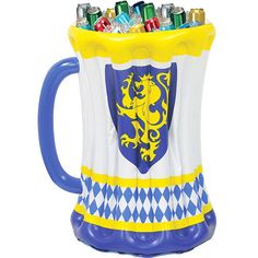 a blue and white coffee mug with a yellow dragon on the front is filled with beer cans