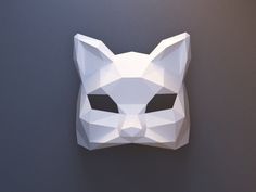 an animal mask made out of white paper on a wall with black eyes and nose