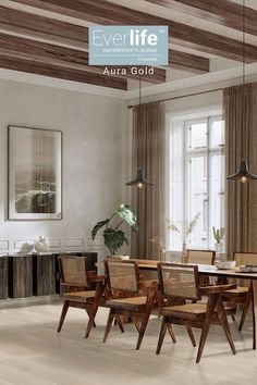 a dining table and chairs in a room with wood flooring, exposed beams and windows