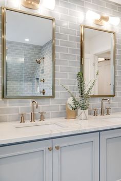 a bathroom with two sinks and mirrors on the wall