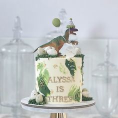 there is a cake decorated with an image of a dinosaur