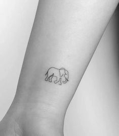 an elephant tattoo on the wrist is shown in this black and white photo, it looks like