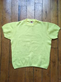 "This is a sweet wool mix sweater in a lovely lemon yellow shade.  Hails from the 1960s and has a distinctly Grease feel about it ! Very suitable for those summer nights.  Sourced in Paris and was part of a Prada designer's Archive.  Size - fits well like a UK size 10 - 12 , chest - 40\" ; length - 22.5\" ; sleeve length - 7.5\"" Yellow Knit Sweater For Spring, Retro Crew Neck Knit Top, Retro Textured Knit Crew Neck Top, Retro Textured Knit Spring Tops, Vintage Crew Neck Knit Top, Retro Textured Knit Top, Vintage Knit Crew Neck Top, Spring Yellow Knit Sweater, Sporty Yellow Cotton Sweater