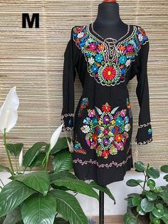 Beautiful Mexican dress embroidered in bright colors with silk thread, its sleeve is 3/4 with embroidered details on the cuffs. The embroidery for each dress is unique so the colors may vary. Mexican textile art has centuries of history and creativity throughout the country. Mexico is recognized as one of the leading countries with a beautiful artistic production in the textile world, miraculous hands of talented artisans from different states of the country create stunning embroidery clothing, Multicolor Embroidered Tunic Dress For Festivals, Long Sleeve Dress With Embroidered Border For Festivals, Traditional Multicolor Embroidered Long Sleeve Dress, Multicolor Folk Dresses With Resham Embroidery, Traditional Embroidered Floral Dress For Spring, Traditional Floral Embroidered Dress For Spring, Spring Multicolor Embroidered Dress With Neckline Detail, Traditional Spring Floral Embroidered Dress, Long Sleeve Folk Dress With Embroidered Border