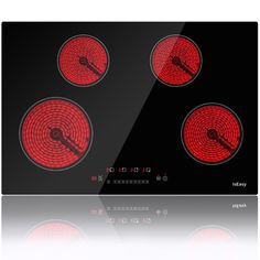 an electric stove top with four burners on the front and red lights on the back