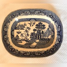 a decorative blue and white plate on display