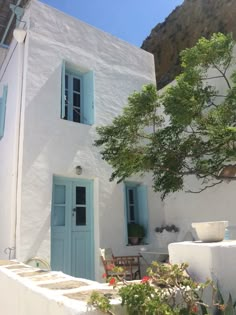 a white house with blue doors and windows