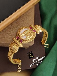 Description :- Antique gold plated South Indian chain bracelet | Gold Plated Bracelet temple jewelry | Bangle bracelet with matte finish | Indian Designs Gift yourself a royal look with this perfectly crafted kundan necklace set from Manalisstudio. Crafted with high quality kundan stones and pearls, it is impressive in design. The green enamel artwork adds perfect texture to the design. Perfect for weddings and festivities, this antique necklace set should be put on with your favorite sari or le Luxury Temple Jewelry Bracelets For Puja, Temple Bracelet, Indian Designs, Temple Jewelry, Gold Plated Bracelet, Wedding Jewelry Bracelets, Kundan Necklaces, Antique Necklace, Gold Bracelet Chain