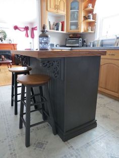 two stools sit at the center of this kitchen island