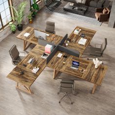 an overhead view of a modern office with wooden tables and chairs