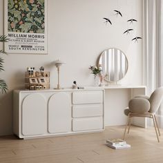 a living room with white furniture and birds on the wall above it's mirror