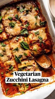 lasagna casserole with spinach, cheese and sauce in a baking dish