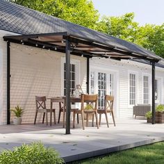 an outdoor patio with chairs and tables under a pergolated awning next to a white house