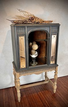 an old fashioned oven with some bread in it's door and wood flooring