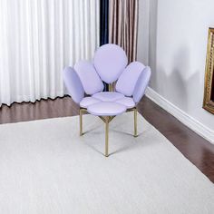 a purple chair sitting on top of a white rug