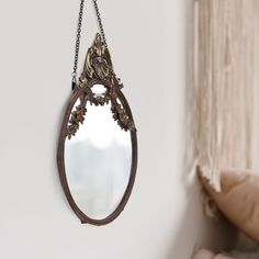 a mirror hanging from the side of a wall