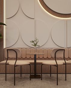 three chairs and a table in front of a wall with circular circles on it's side