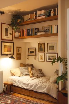 a small bed with pillows and blankets in a room next to a radiator