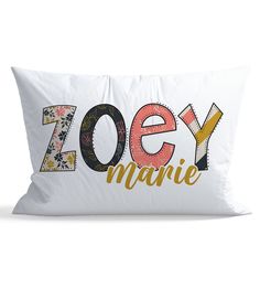 a white pillow with the word zooy marie printed on it and an orange flower