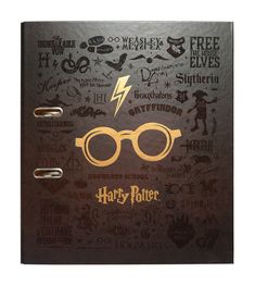 a harry potter notebook with hogwart's glasses and other symbols on the cover