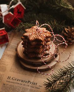 some cookies are stacked on top of each other and tied with twine, next to christmas decorations