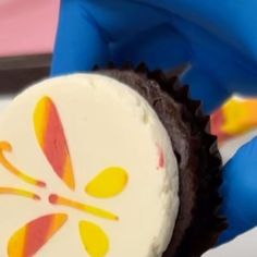 a close up of a person holding a cupcake