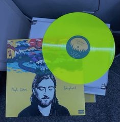 two yellow records sitting on the ground next to each other with an image of jesus