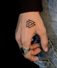 a person with a small tattoo on their hand